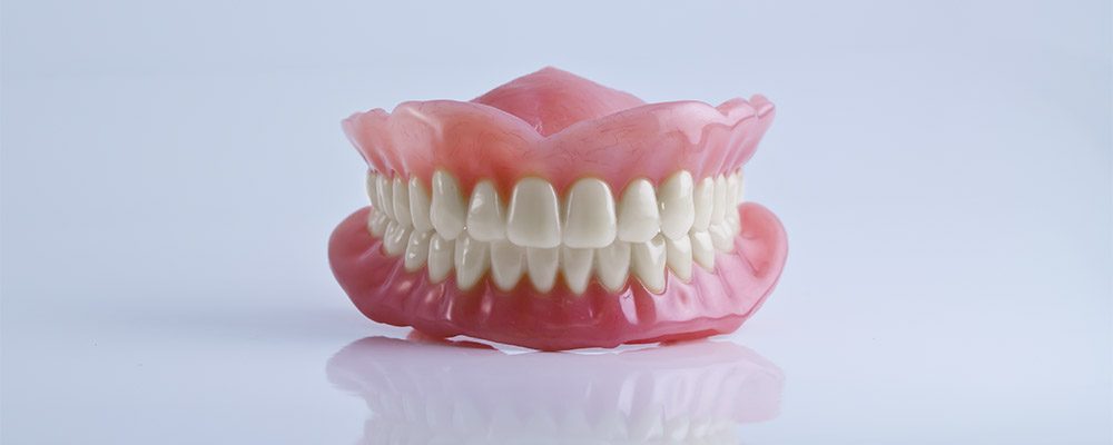 full set of acrylic denture isolated on white background